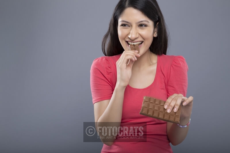 woman eating chocolate in a messy way