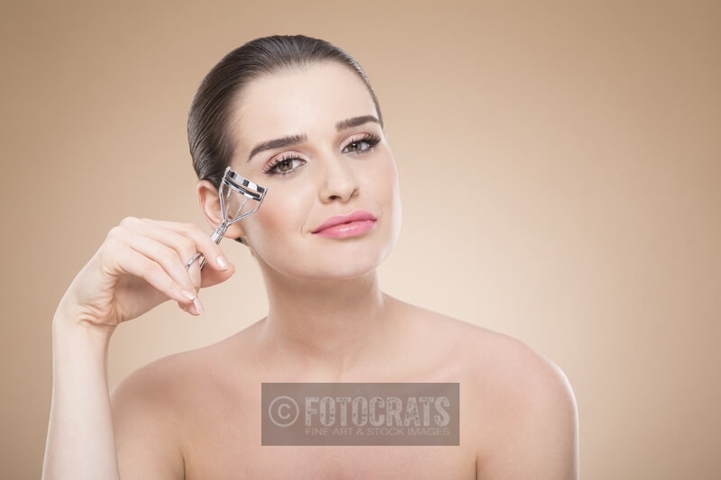 girl posing with eyelash curler