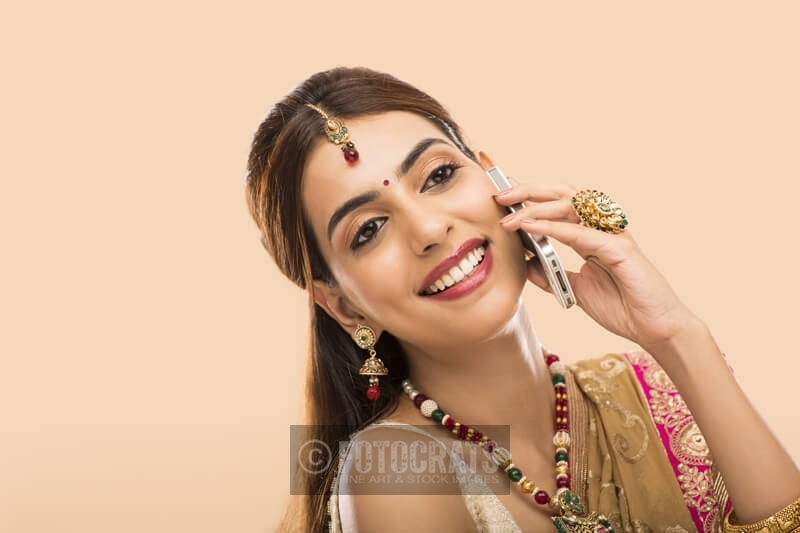 woman in traditional wear talking on phone 