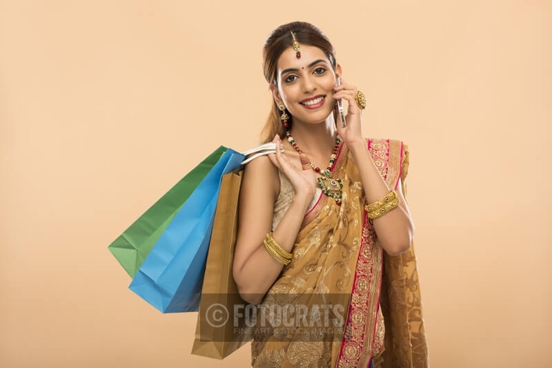 woman with shopping bags and mobile phone