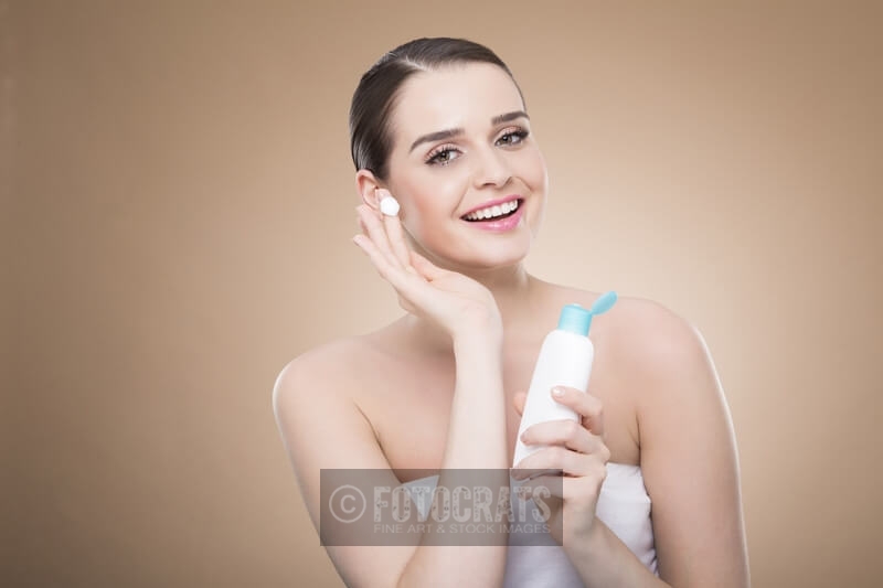 beautiful girl applying cream 