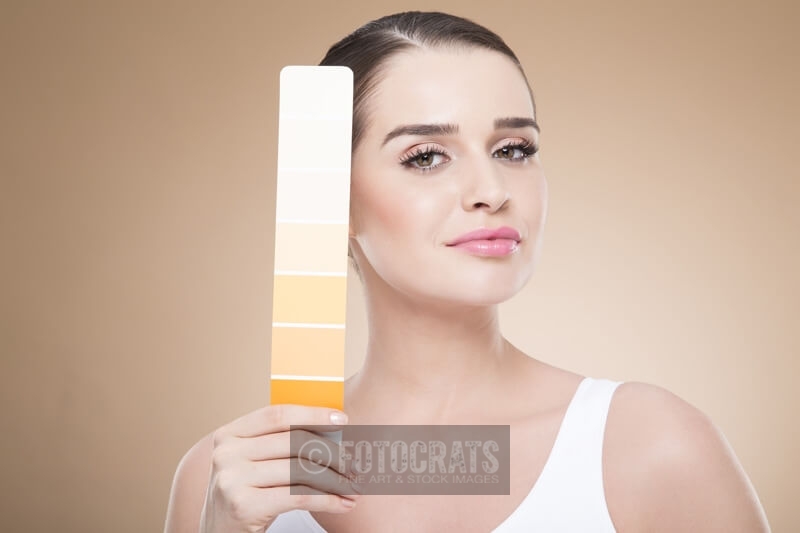 woman with skin shade card