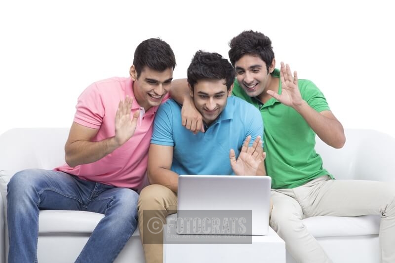 three friends looking at the laptop