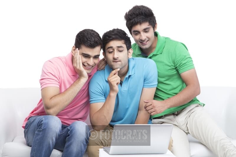 friends having fun time while browsing on laptop