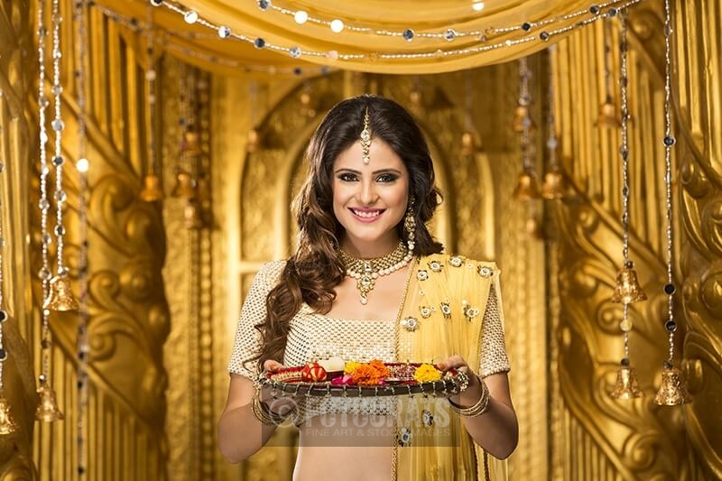woman in traditional wear with pooja thali
