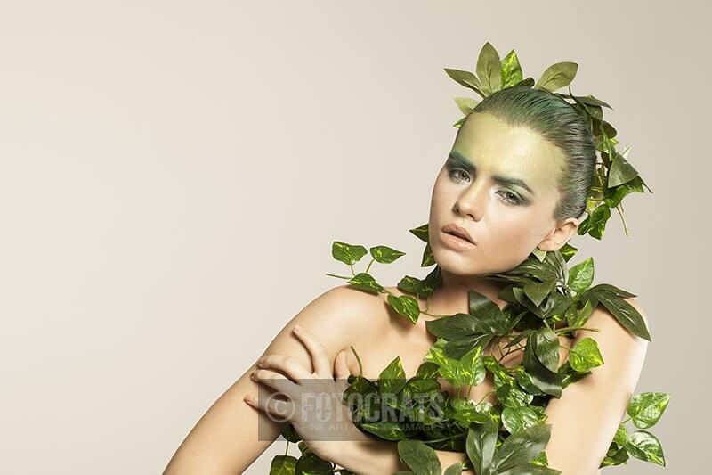 woman covered with green leaves
