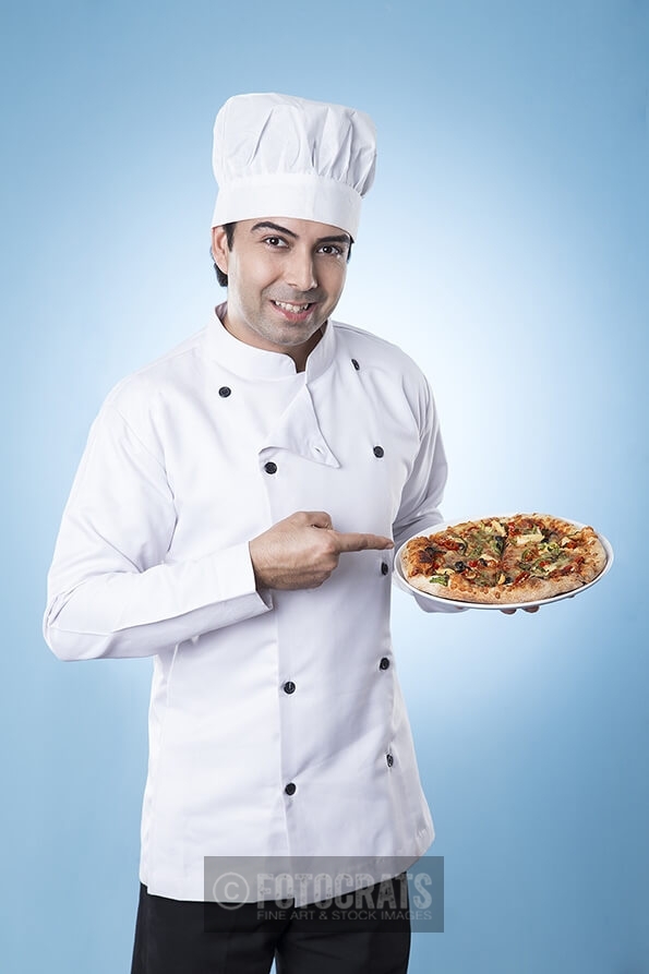 chef posing with pizza