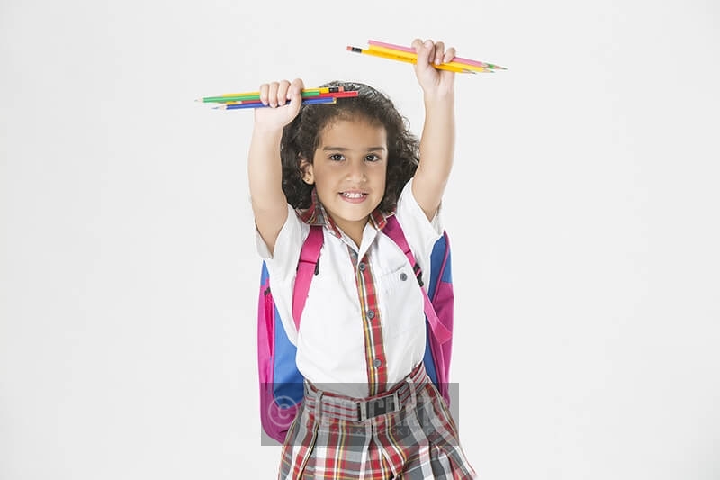 girl in school uniform with notebook and pencil 