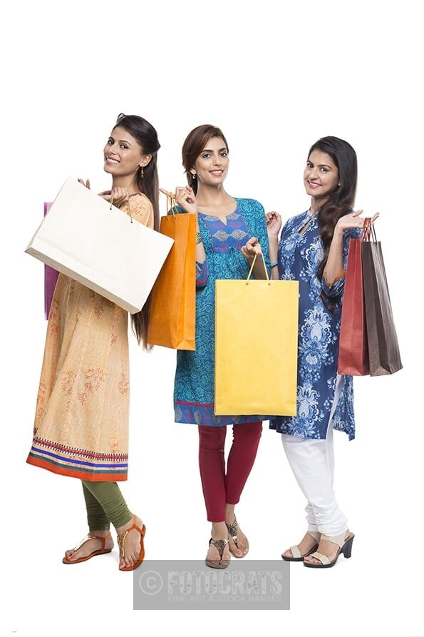 Three Indian women with shopping bags