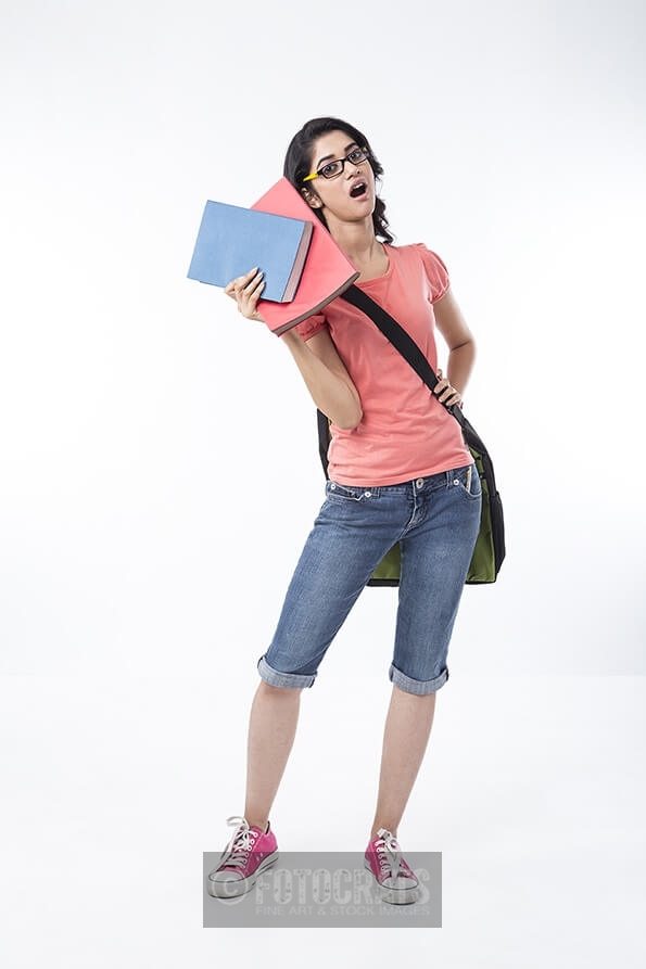 college girl holding text books and posing