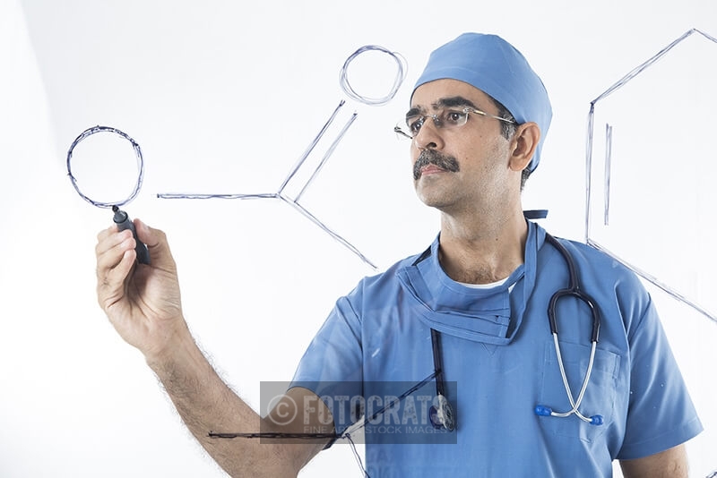 male doctor writing transparent screen