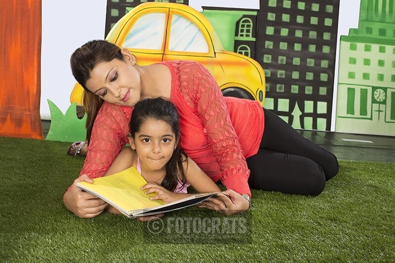 mother and daughter in garden reading book