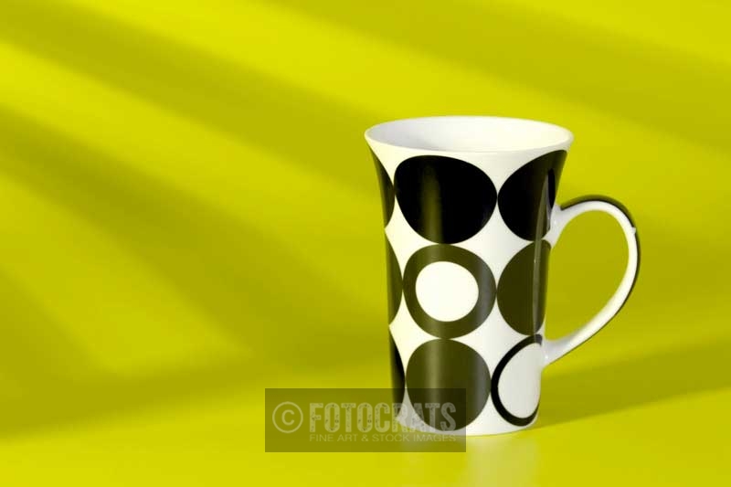 coffee cup against a yellow background
