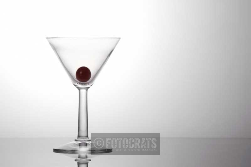 a piece of fresh grape in a cocktail glass