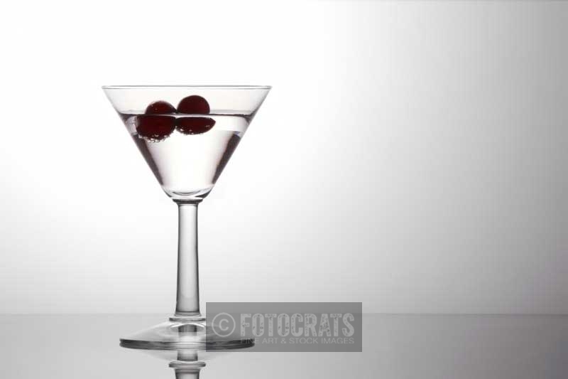 alcohol in a cocktail glass with cherries