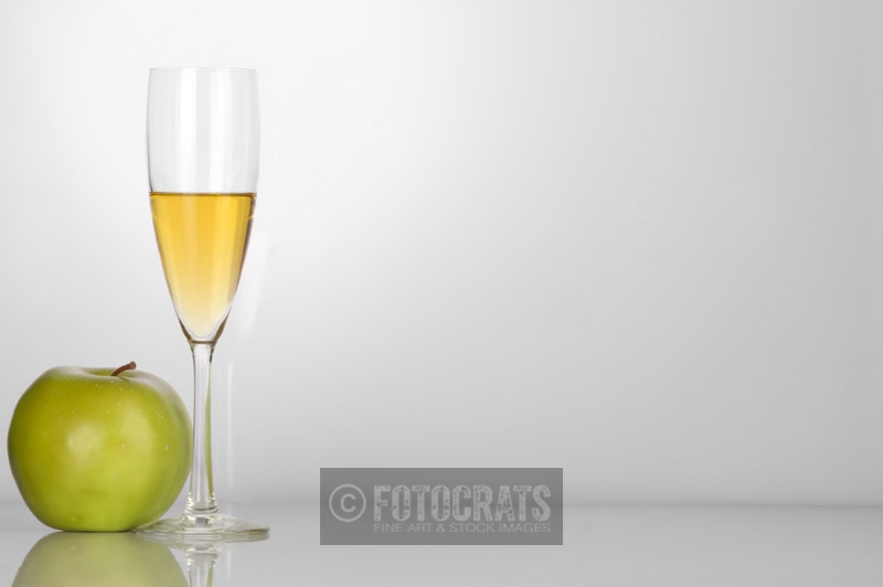 champagne glass with white background and green apple