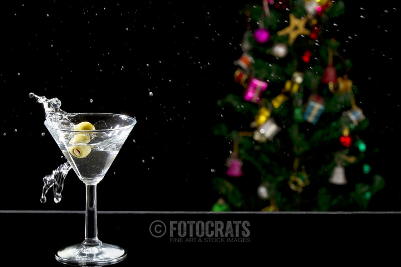 a martini drink with olives in motion