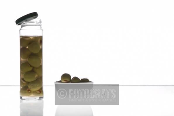 olives in a jar and  a bowl