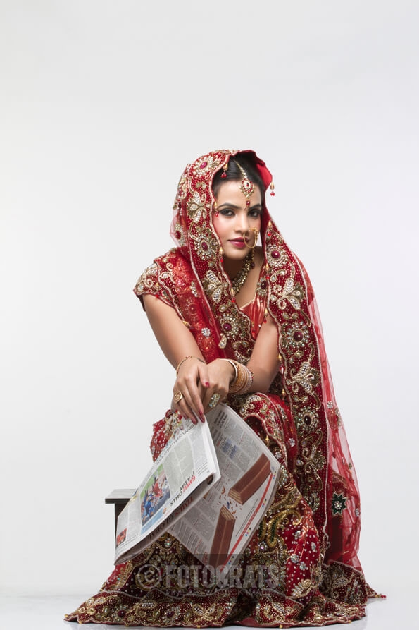 indian bride with a newspaper 