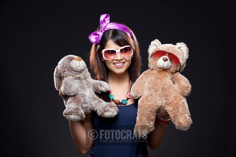 teenage girl holding her teddy bears