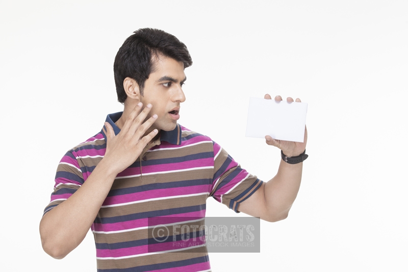 man posing with a white card