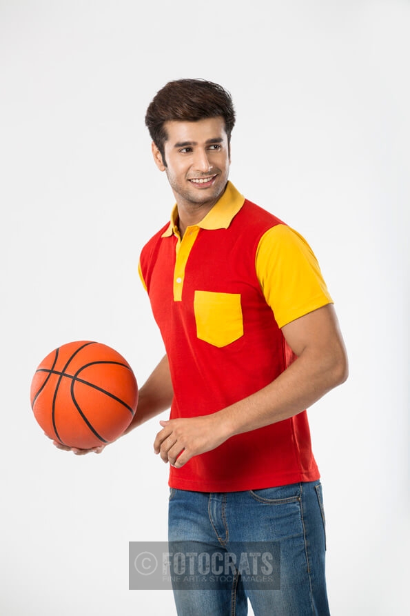 college boy with basketball posing for the camera 
