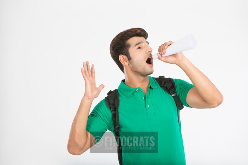 college boy using rolled sheet as loudspeaker