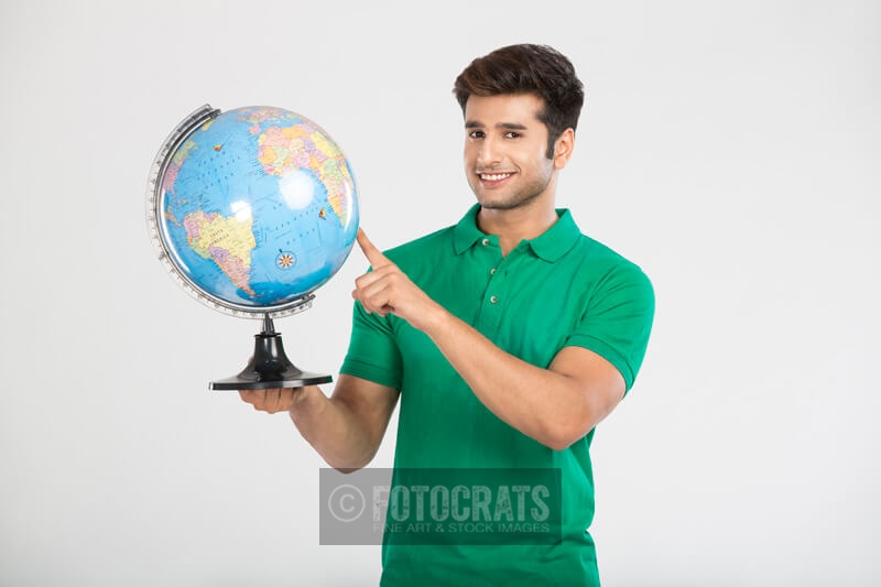 man pointing at the globe