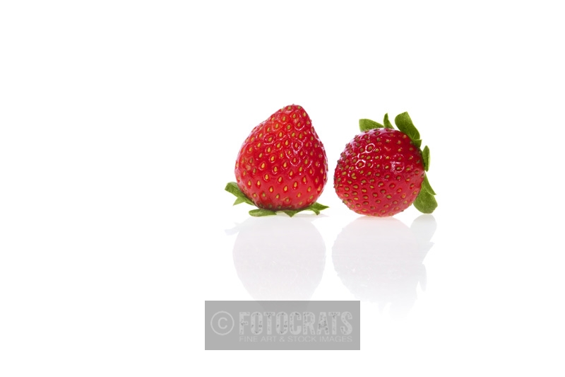 pair of strawberries against white background with copy space for adve