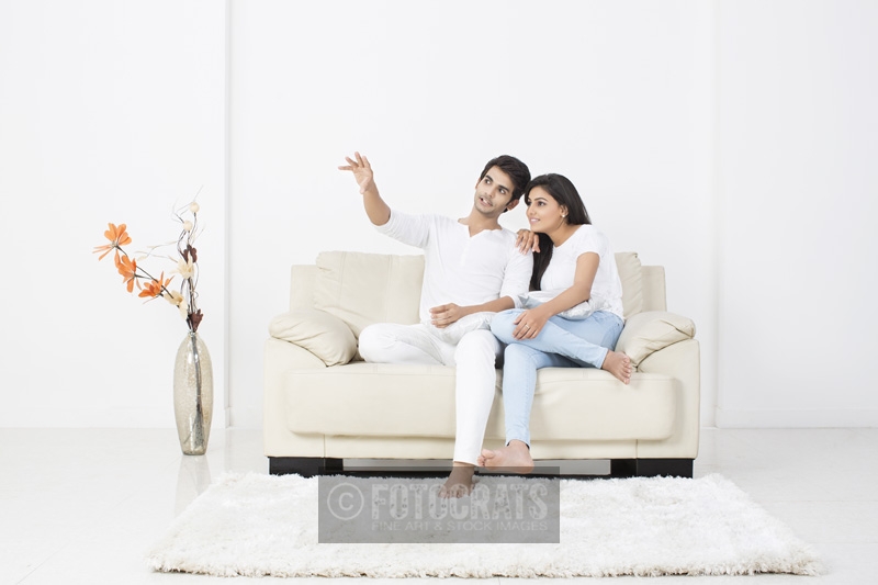couple conversing while sitting on couch