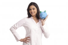 woman in a pink shirt posing with a blue piggy bank
