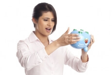 beautiful corporate woman looking at the piggy bank