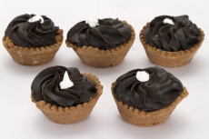five cupcakes with vanilla topping