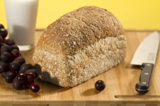 fresh brown bread with glass of milk and fruits