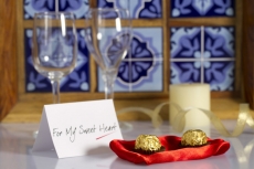 chocolate balls and a note on the table with champagne glasses