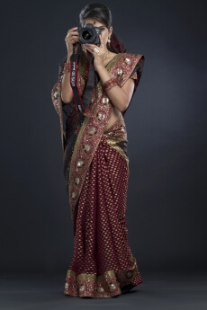 woman in an indian saree taking a picture
