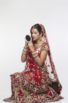 indian bride looking into the mirror 