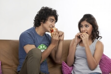 teenage couple enjoying snacks 