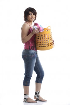 side view of a housewife holding a basket of clothes