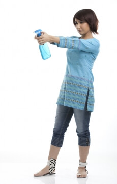 portrait of a housewife with a spray bottle in hand