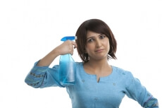 housewife with a spray bottle over her head