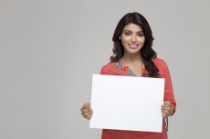 girl displaying blank white board