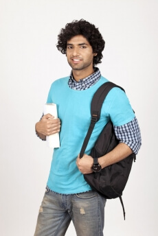 college boy posing with backpack and book 