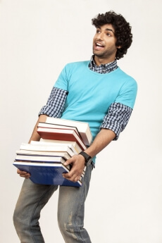 college boy overloaded with books 