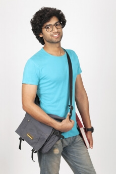 college boy posing while holding his bag 
