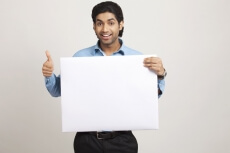 man showing thumps up while holding placard