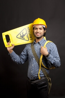 man carrying  caution stand and posing while looking at the camera