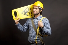 man carrying caution board with rope