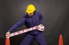man applying caution tape