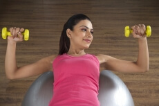 attractive girl with yellow coloured dumbbells